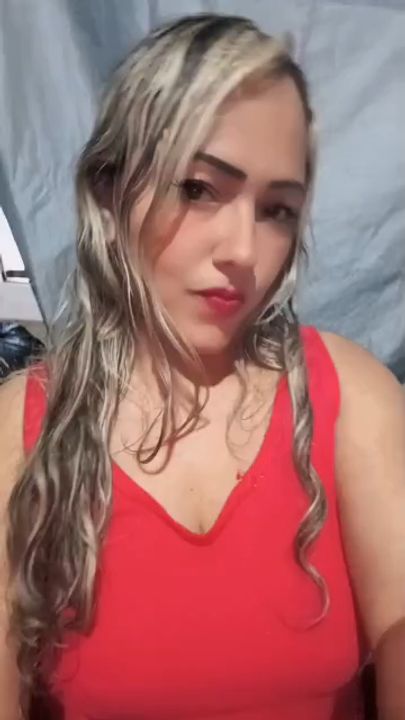 A woman in a red top chatting on camera