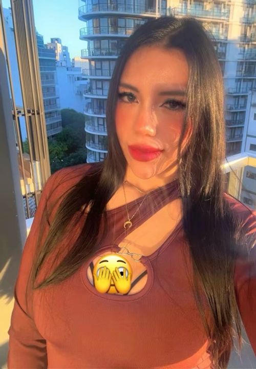Woman on a balcony at golden hour, smiling for a random video chat